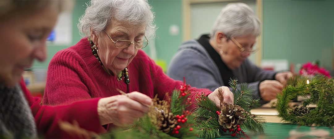 Seniors doing holiday activities at a table.